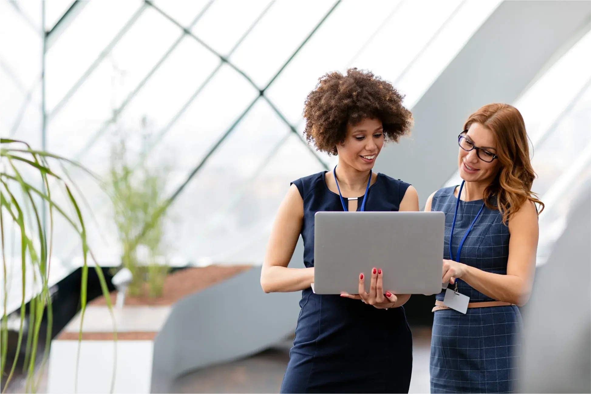 Two advisors reviewing a cash flow forecast together on a laptop in a modern office